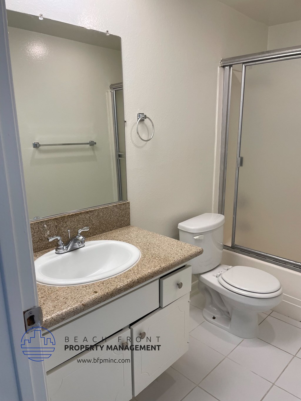 a white bathroom with a sink toilet and shower